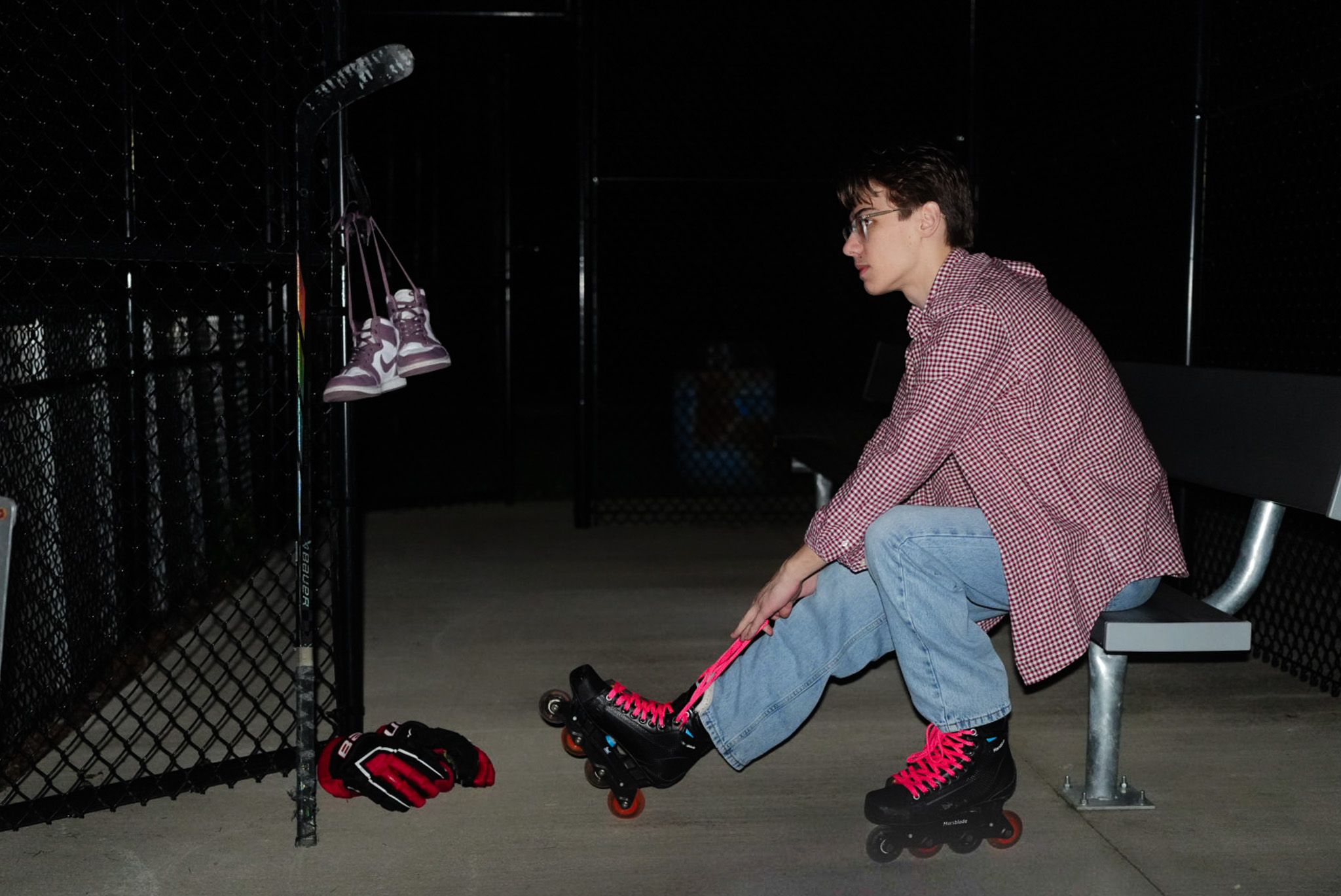 Lacing up on the bench at the rink before filming.