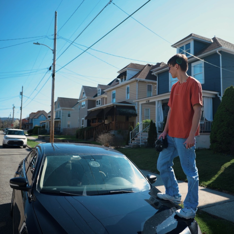 Mikey Cabiles out shooting on a small-town street, camera in hand.